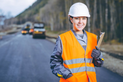 Female worker road construction infrastructure repair pavement